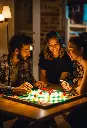 3 friends man and woman playing board game by nigh.webp